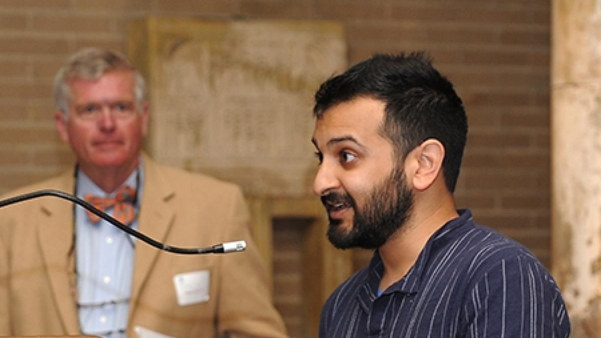 Nirav Mehta, one of the co-winners of this year's Carey Prize, expresses his thanks while Francis Carey III looks lon.